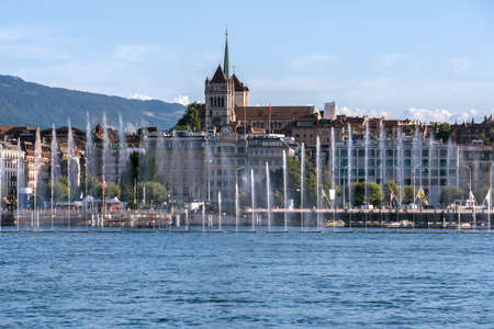 Fountain show at the Geneva Lake Festival in august. View from the lake on the Saint Piere Cathedral.のeditorial素材