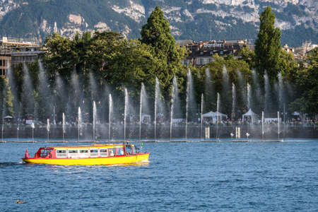 Water yellow tram in Geneva at summer sunny day. View from the lakeのeditorial素材
