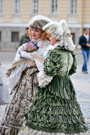 Saint Petersburg, Russia, august 2019. Two women dressed in old fashioned style attractin touristsのeditorial素材