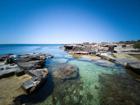 The cristal clear turquoise water of the rocky coast of Favignana, one of the islands of the Egadi archipelago in Sicilyの写真素材