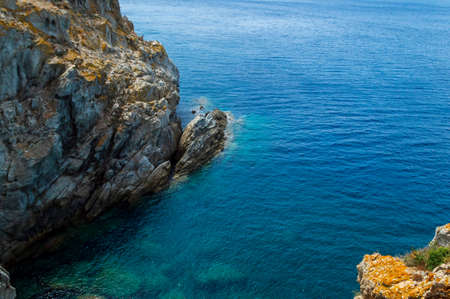 Wild sea landscape with white rocks and blue water in Monte Enfola, Elba island, Italyの写真素材