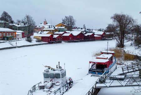 Porvoo, Finland, December 2021. Old wooden red houses by the frozen river Porvoonjokiのeditorial素材