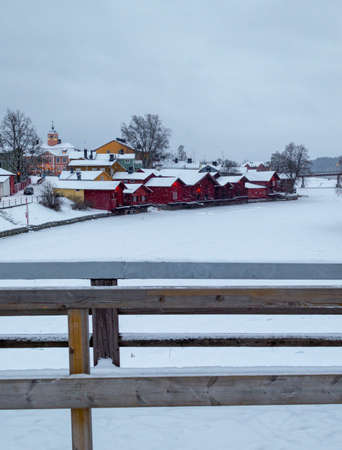 Porvoo, Finland, December 2021. Old wooden red houses by the frozen river Porvoonjokiのeditorial素材