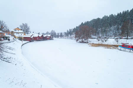 Porvoo, Finland, December 2021. Old wooden red houses by the frozen river Porvoonjokiのeditorial素材