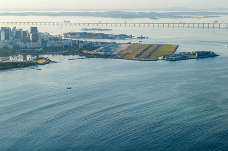 Aerial view of Rio de Janeiro northern area with a plane landing in the local airport Santos Dumondの写真素材