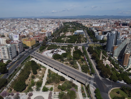 A stunning drone shot of Valencia showscasing the lush Turia Park, winding through the former Turia River bed, surrounded by the city's vibrant urban landscape.の写真素材