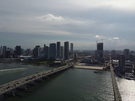 Wide daytime drone photo of Biscayne Bay facing Midtown and Downtown Miami, with skyline and blue waters under clear skiesの写真素材