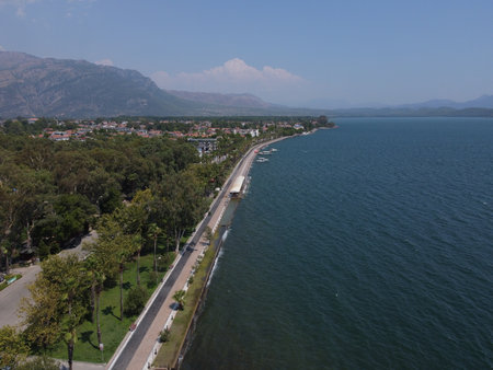 A serene aerial view of Lake KÃ¶yceÄiz in Turkey on a calm summer day, showcasing tranquil blue waters, lush surroundings, and peaceful natural beauty.の写真素材