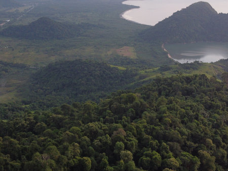 Sunset drone video over Paraty, Brazil, reveals lush Atlantic Forest, golden skies, and small islands scattered along the glowing coastline.の写真素材