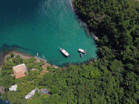 A stunning drone view of Paraty Bay with Ilha dos Cocos, crystal-clear waters, lush islands, and vibrant summer vibes.の写真素材