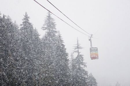 Cable car in the snowfallの写真素材