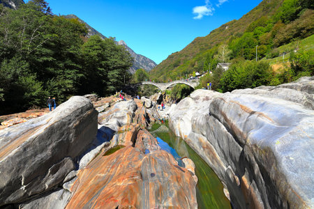 Lavertezzo, Switzerland - September 28, 2020: Visiting the ancient double arch stone bridge in Lavertezzo on a sunny day in September.のeditorial素材