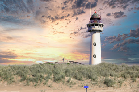 Lighthouse at sunset in the twilight. Egmond aan Zee, North Sea, the Netherlands.の写真素材