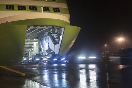 Unloading cars from big, green ferryの写真素材