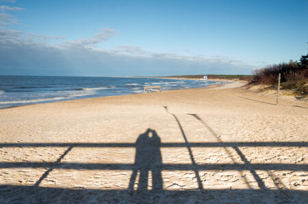 Shadow of a hugging couple on a beachの写真素材