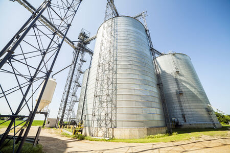 Huge silver shiny agricultural silos.の写真素材