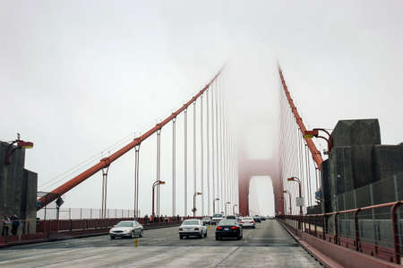 Car traffic on Golden Bridge in a mist, San Francisco, USAの写真素材