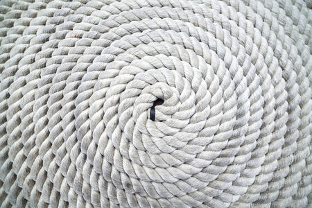 Long rope coiled on dockの写真素材