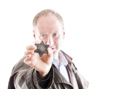 Sheriff presents his sheriff star badge isolated on whiteの写真素材