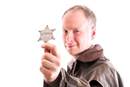 Man holds sheriff badge isolated on white backgroundの写真素材