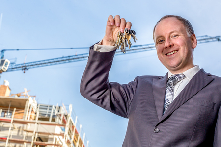 Bunch of keys in hand of elegant manの写真素材