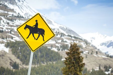 Horse Riders road sign located in beautiful mountainsの写真素材