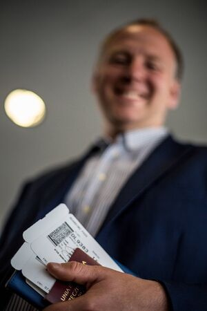 Man with boarding pass and passport at the airportの写真素材