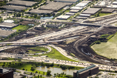 Road construction in industrial area photographed from aboveの写真素材