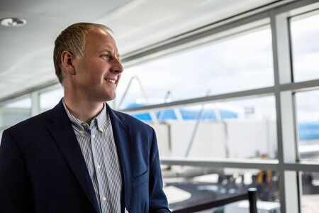 Elegant man at the airport happy to travel