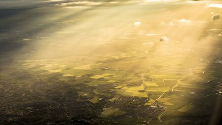Fields, forest and sunbeam from above Netherlandsの写真素材
