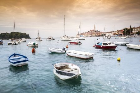 Boats on turquoise sea and Historic buildings of beautiful Rovinj, Croatia, Europeの写真素材