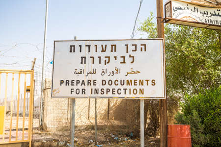 'Prepare documents for inspection" sign in English, Hebrew and Arabic at Israeli and palestinian borderの写真素材