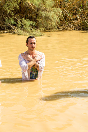 Jericho, Israel - November 2, 2015: Organized baptism for group of pilgrims in river of Jordan, the place which is believed that Jesus was baptizedのeditorial素材
