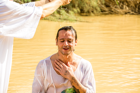 Jericho, Israel - November 2, 2015: Organized baptism for group of pilgrims in river of Jordan, the place which is believed that Jesus was baptizedのeditorial素材