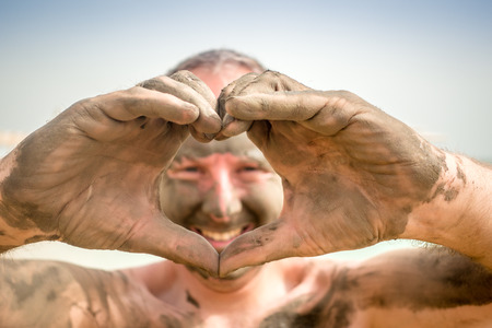 Man enjoying mud from Dead Sea, Israel, Middle Eastの写真素材