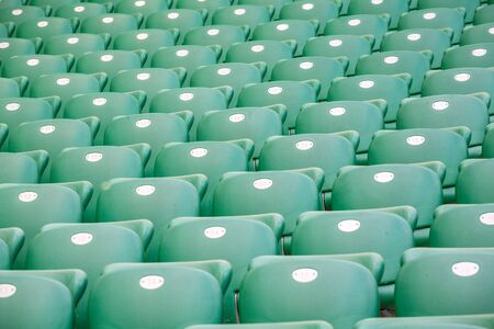 Green plastic seats on the tribune at modern stadiumの写真素材