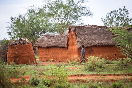 Samburu, Kenya - December 10, 2016: Young girl walking in traditional african villageのeditorial素材