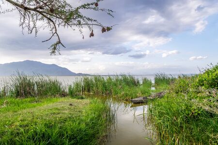 Boat and Lake Jipe at sunset, Tsavo West National Park, Kenyaの写真素材
