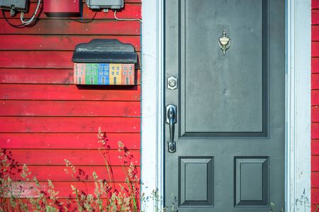Green doorway and colorful mailbox with wooden traditional houses in St. Johns, Newfoundland, Canadaの写真素材