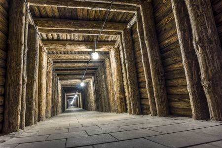 Illuminated underground tunnel in old, salt mine in Bochnia, Polandの写真素材