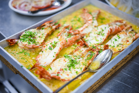 Baked tiger shrimps in a butter sauce on oven-panの写真素材