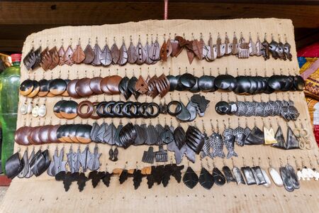 Beautiful wooden earrings being sold on open air market FEIMA in Maputo, Mozambique