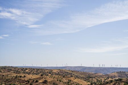Windmills on the horizon in hilly region of Portuguese Spanish border