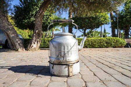 Strong black coffee in silver kettle sold by street vendor in Marrakech, Moroccoの写真素材