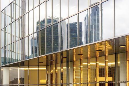 Skyscrapers reflected in glass facade of modern building in London, United Kingdom