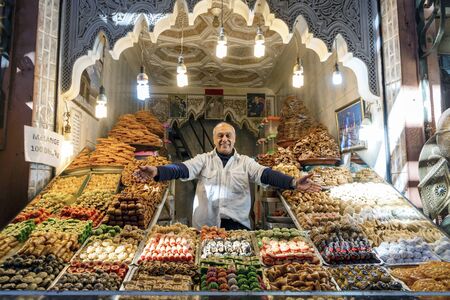 Marrakech, Morocco - January 7,2020: Man presenting his shop with delicious baklavas located in old town of Marrakechのeditorial素材