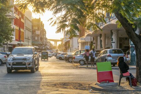 Regular car and human traffic on the downtown  street of Maputo, Mozambique