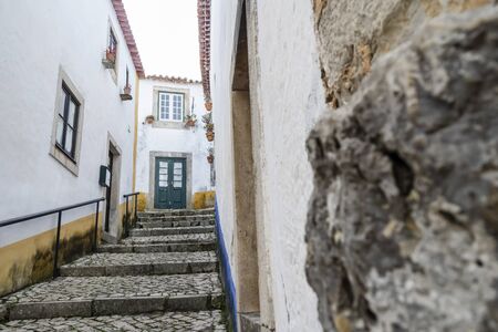 Charming architecture in beautiful town of Obidos surrounded by stone walls, Leiria district, Portugalの写真素材