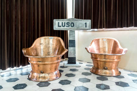Luso, Portugal - December 14, 2019: Vintage, golden and shiny thermal bathtubs