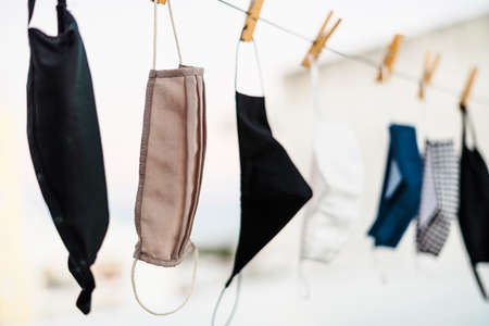 Washable protective face masks drying up on the rope
